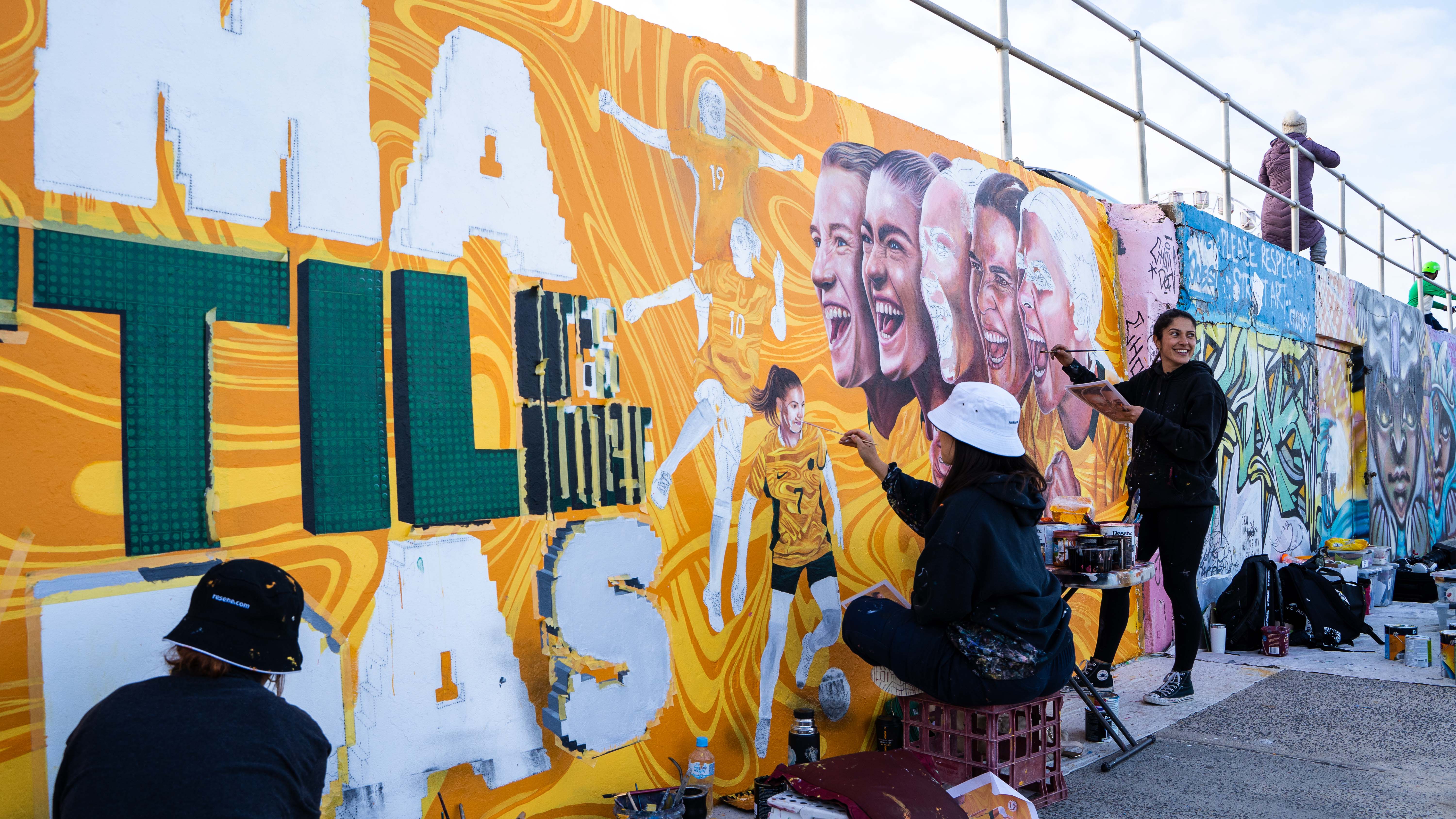 A progress shot of the CommBank Matildas mural at iconic Bondi Beach. (Artist: Danielle Weber)
