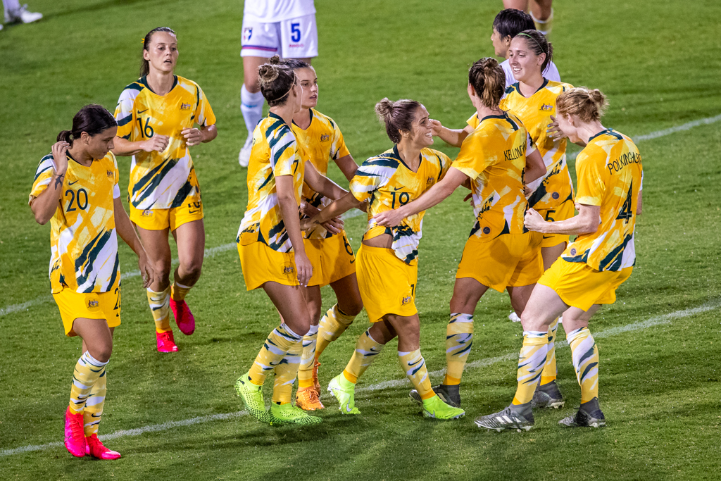 Katrina Gorry is swamped by teammates after scoring the Westfield Matildas' seventh