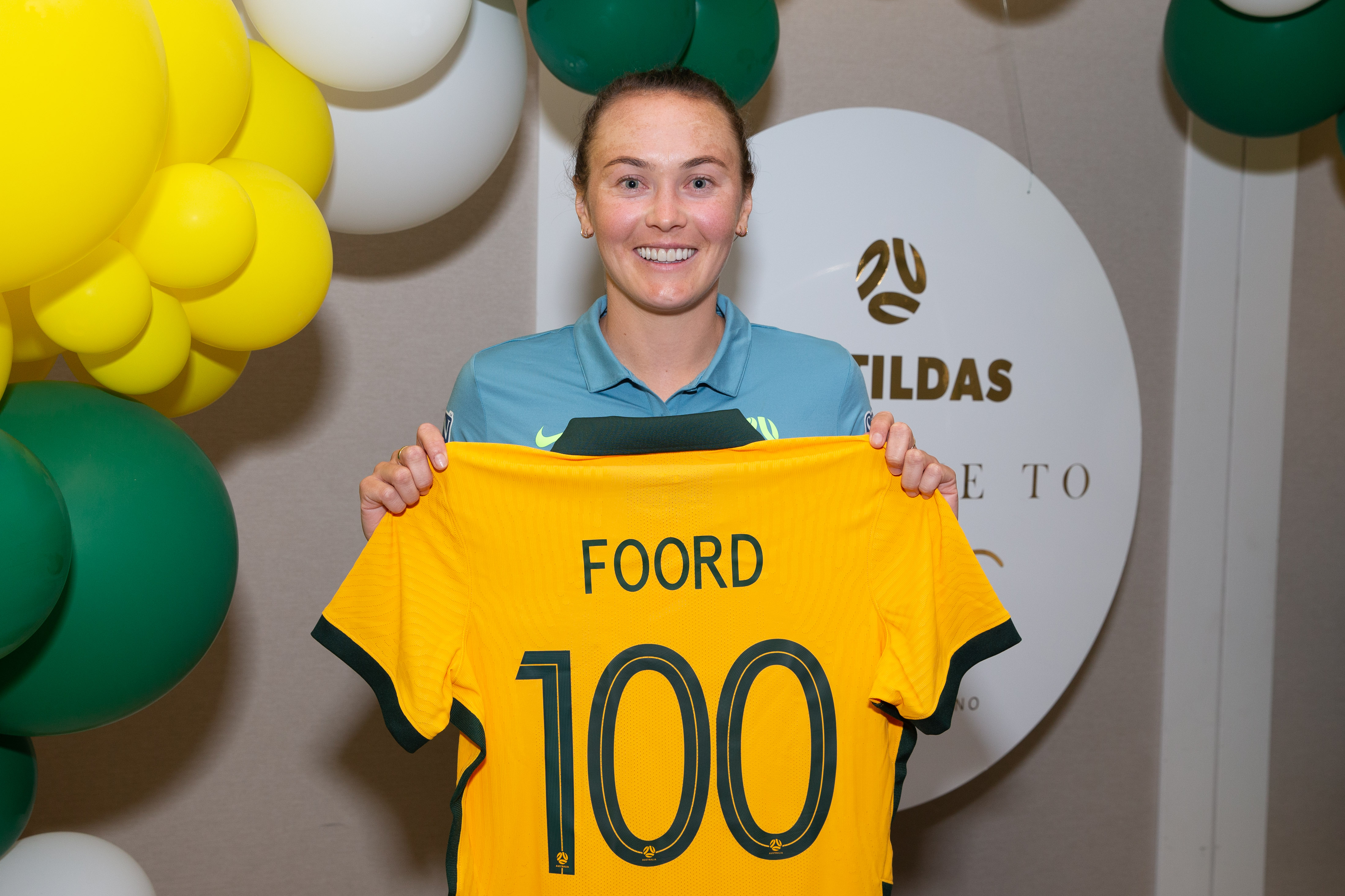 Caitlin Foord posing with her 100 jersey, April 2022.