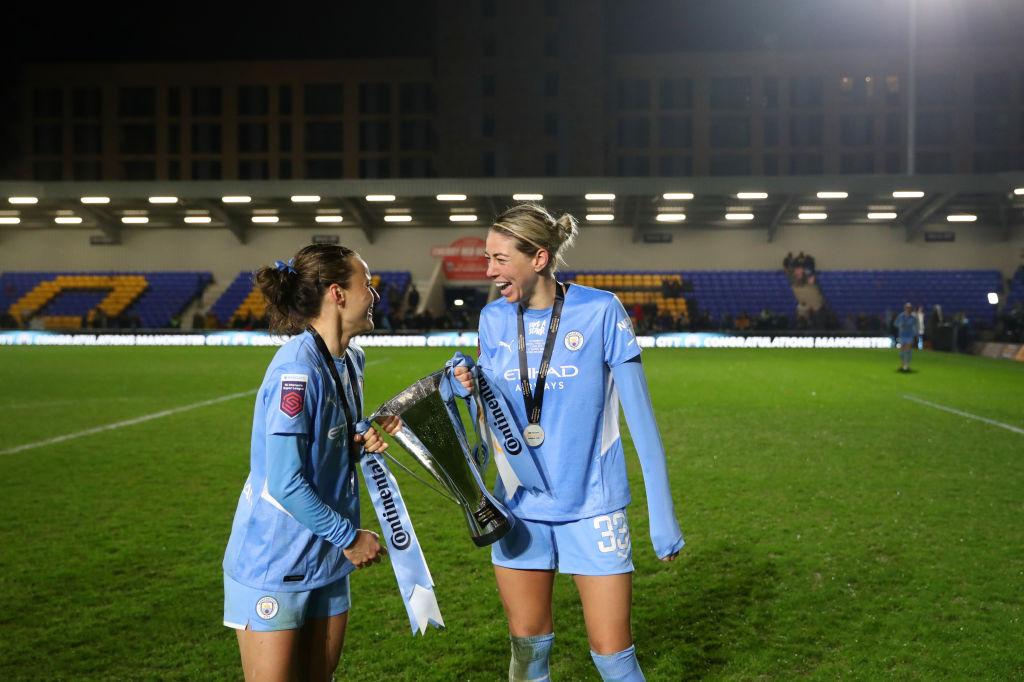 Hayley Raso and Alanna Kennedy of Manchester City celebrates with The FA Women's Continental Tyres League Cup trophy following their side's victory in the FA Women's Continental Tyres League Cup Final match between Chelsea Women and Manchester City Women at The Cherry Red Records Stadium on March 05, 2022 in Wimbledon, England. (Photo by Catherine Ivill - The FA/The FA via Getty Images)