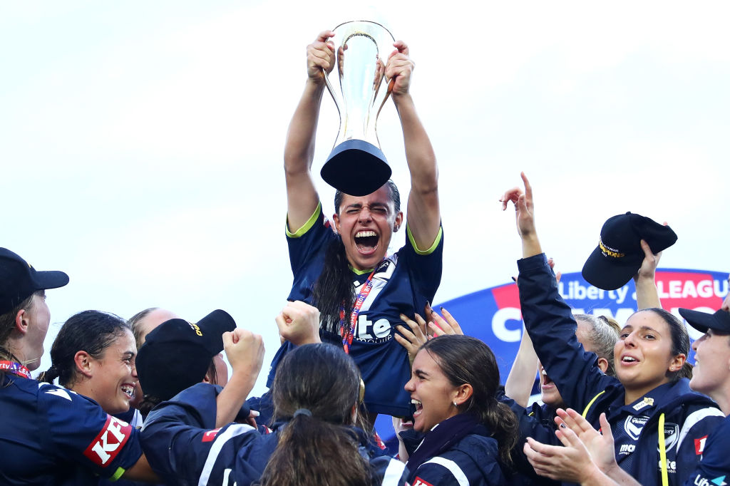 Alex Chidiac of the Victory holds up the trophy as she celebrates with her team after winning the A-League Womens Grand Final match between Sydney FC and Melbourne Victory at Netstrata Jubilee Stadium on March 27, 2022, in Sydney, Australia. (Photo by Mark Metcalfe/Getty Images)
