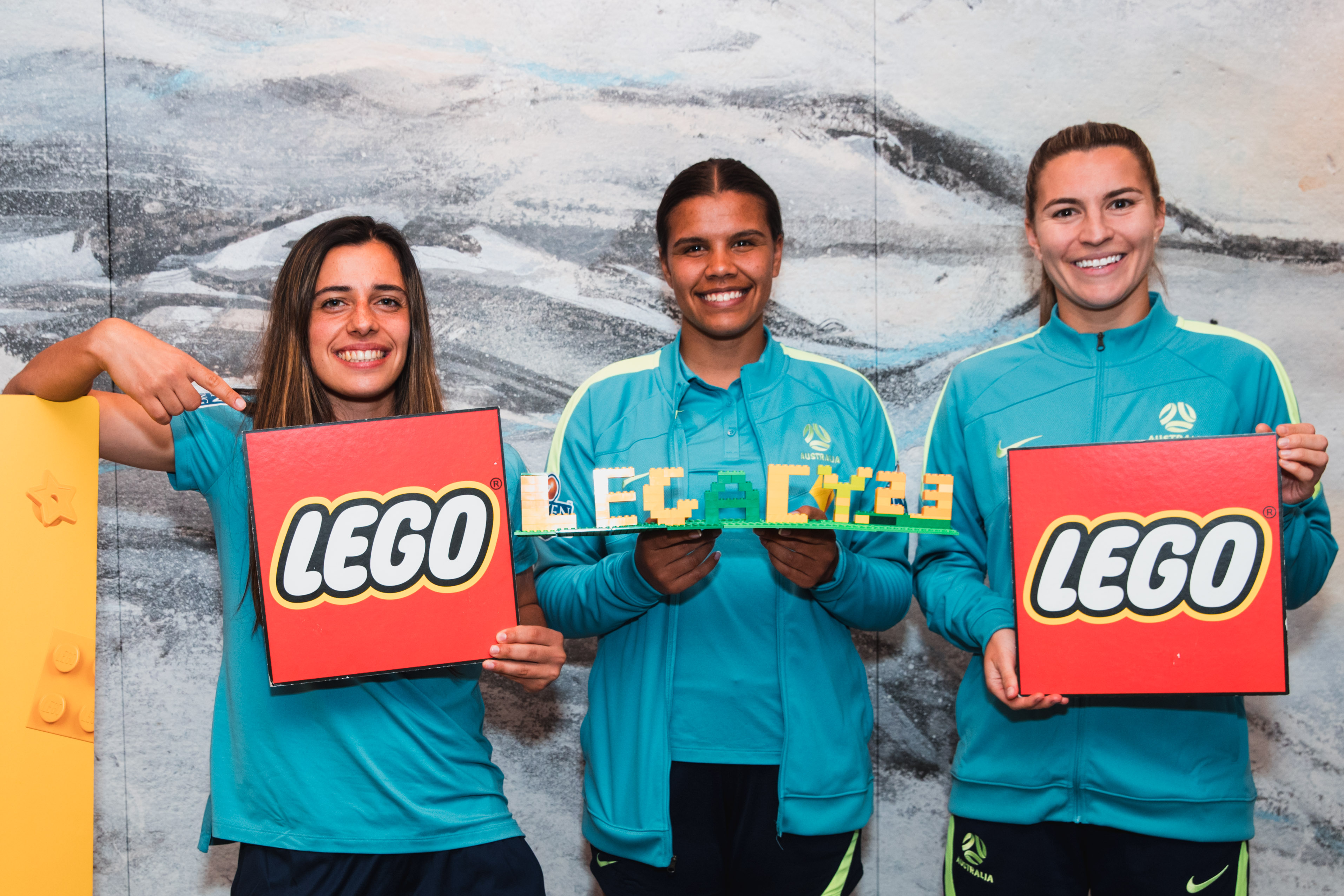 Alex Chidiac, Jada Whyman & Steph Catley posing with Lego following the new partnership.