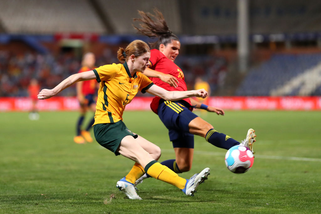  Cortnee Vine of Australia crosses the ball past Andrea Pereira of Spain during the Women's International Friendly match between Spain and Australia at Estadio Nuevo Colombino on June 25, 2022, in Huelva, Spain. (Photo by Fran Santiago/Getty Images)
