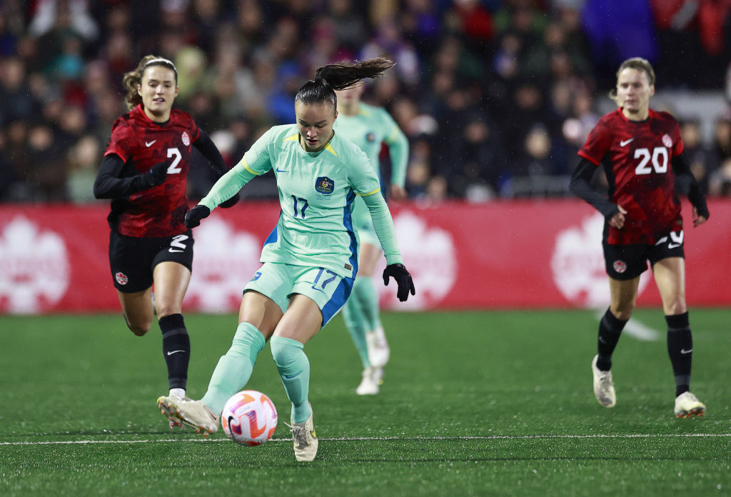 Cloe Lacasse #20 and Sydney Collins #2 of Canada look on as Amy Sayer #17 of Australia plays the ball during the first half of their friendly match at Starlight Stadium on December 01, 2023 in Langford, British Columbia. (Photo by Jeff Vinnick/Getty Images for Football Australia)