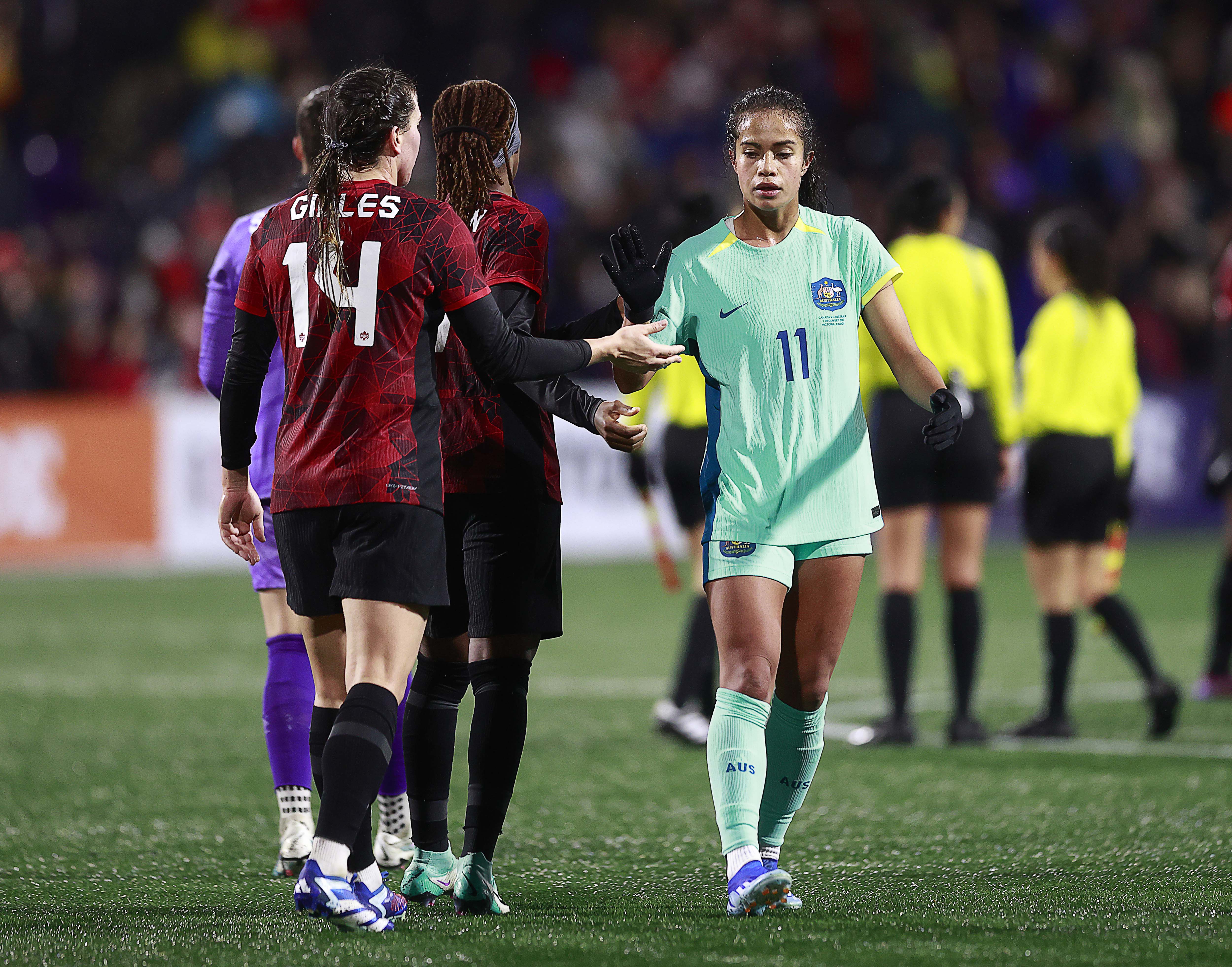 Vanessa Gillies #14 of Canada is congratulated by Mary Fowler #11 of Australia after their friendly match at Starlight Stadium on December 01, 2023 in Langford, British Columbia. Canada won 5-0. (Photo by Jeff Vinnick/Getty Images for Football Australia)