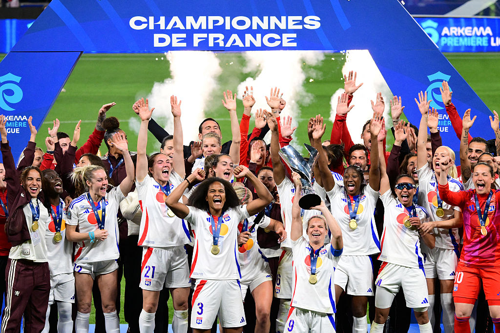 Lyon's players celebrate with the trophy after winning the final of the French D1 women's football match between Olympique Lyonnais (OL) and Paris Saint-Germain (PSG) at the Groupama Stadium in Decines-Charpieu, central-eastern France on May 16, 2025. (Photo by Olivier CHASSIGNOLE / AFP) (Photo by OLIVIER CHASSIGNOLE/AFP via Getty Images)