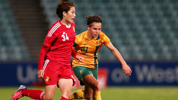 Ash Sykes fights for the ball in a 2013 friendly against China.