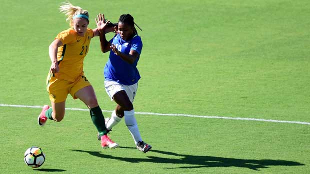 Ellie Carpenter battles for possession with a Brazilian attacker during the Tournament of Nations.