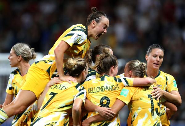 Australia celebrates with teammates after scoring her team's first goal during the 2019 FIFA Women's World Cup France Round Of 16 match between Norway and Australia at Stade de Nice on June 22, 2019 in Nice, France. (Photo by Hannah Peters - FIFA/FIFA via Getty Images)