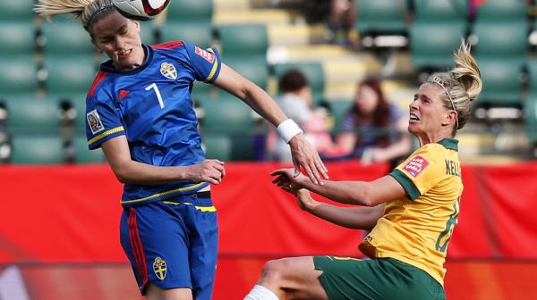 Elise Kellond-Knight competes for a header with Swedish midfielder Lisa Dahlkvist.